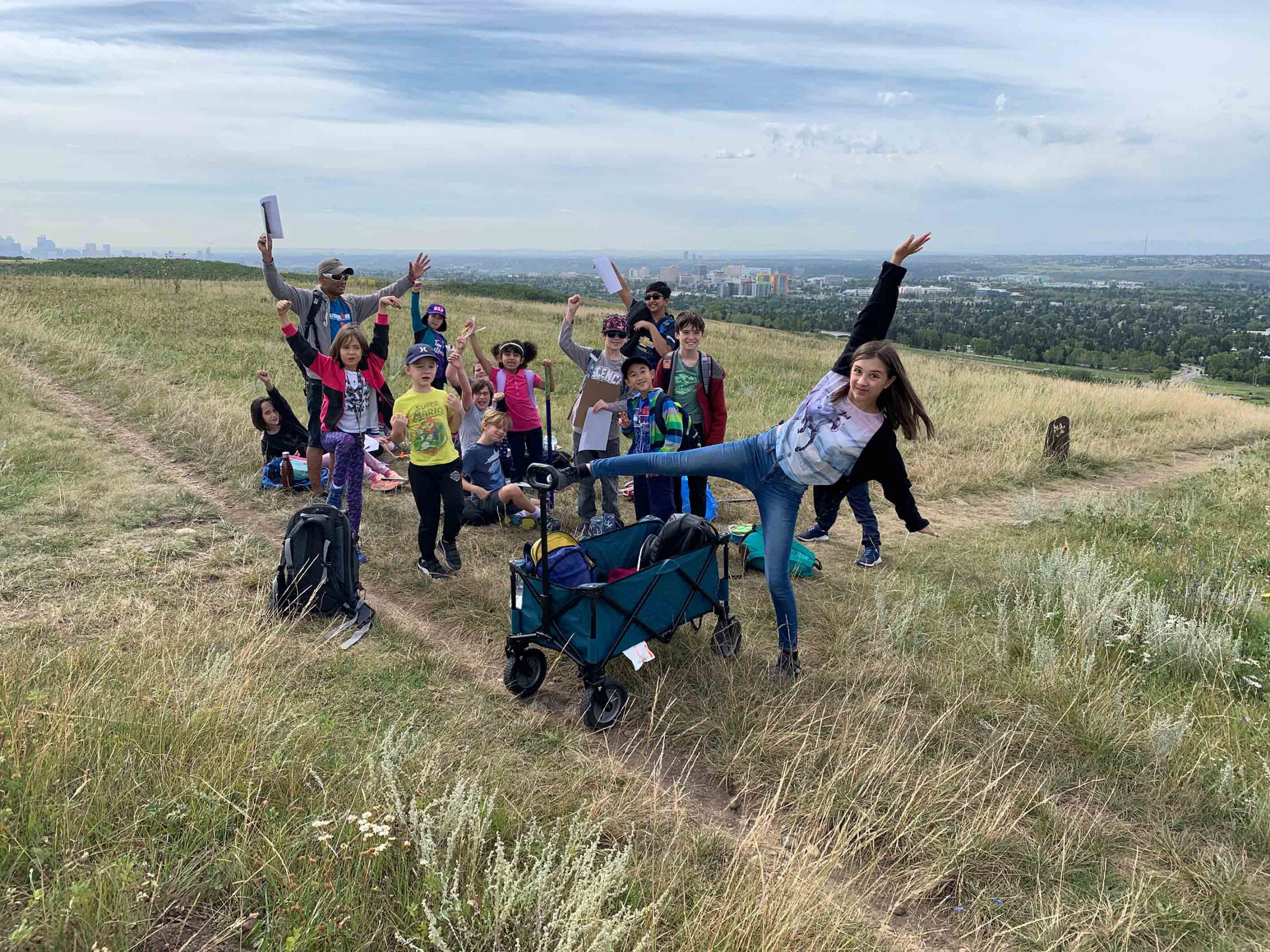 Banbury students on a field trip to Nose Hill posing for a picture by raising their arms